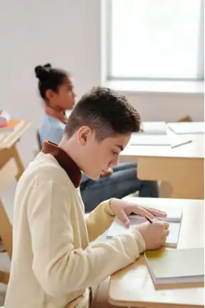 Students at their desks, studying in a classroom