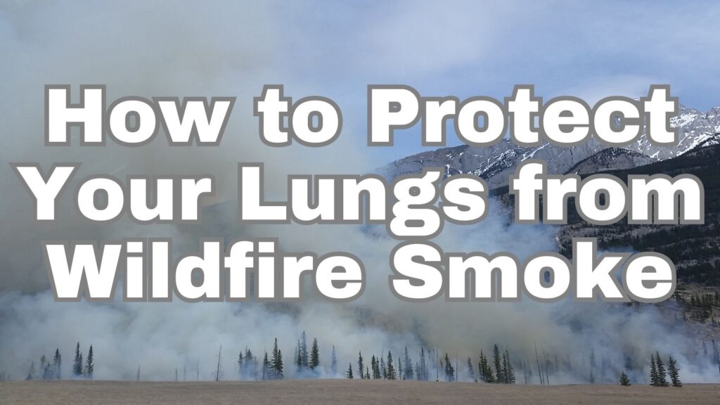 Smoke from wildfires fills the sky in Alberta. Snow capped mountains are in the background. Text on top of image reads "How to Protect Your Lungs from Wildfire Smoke."