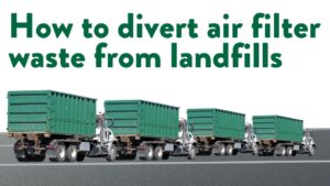 4 identical large green waste disposal trucks drive on a paved road. The truck cabs are white. 